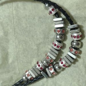 Hot pink jewel and silver necklace on black leather cording